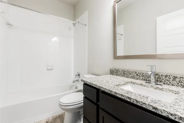 an empty room with a ceiling fan and a window