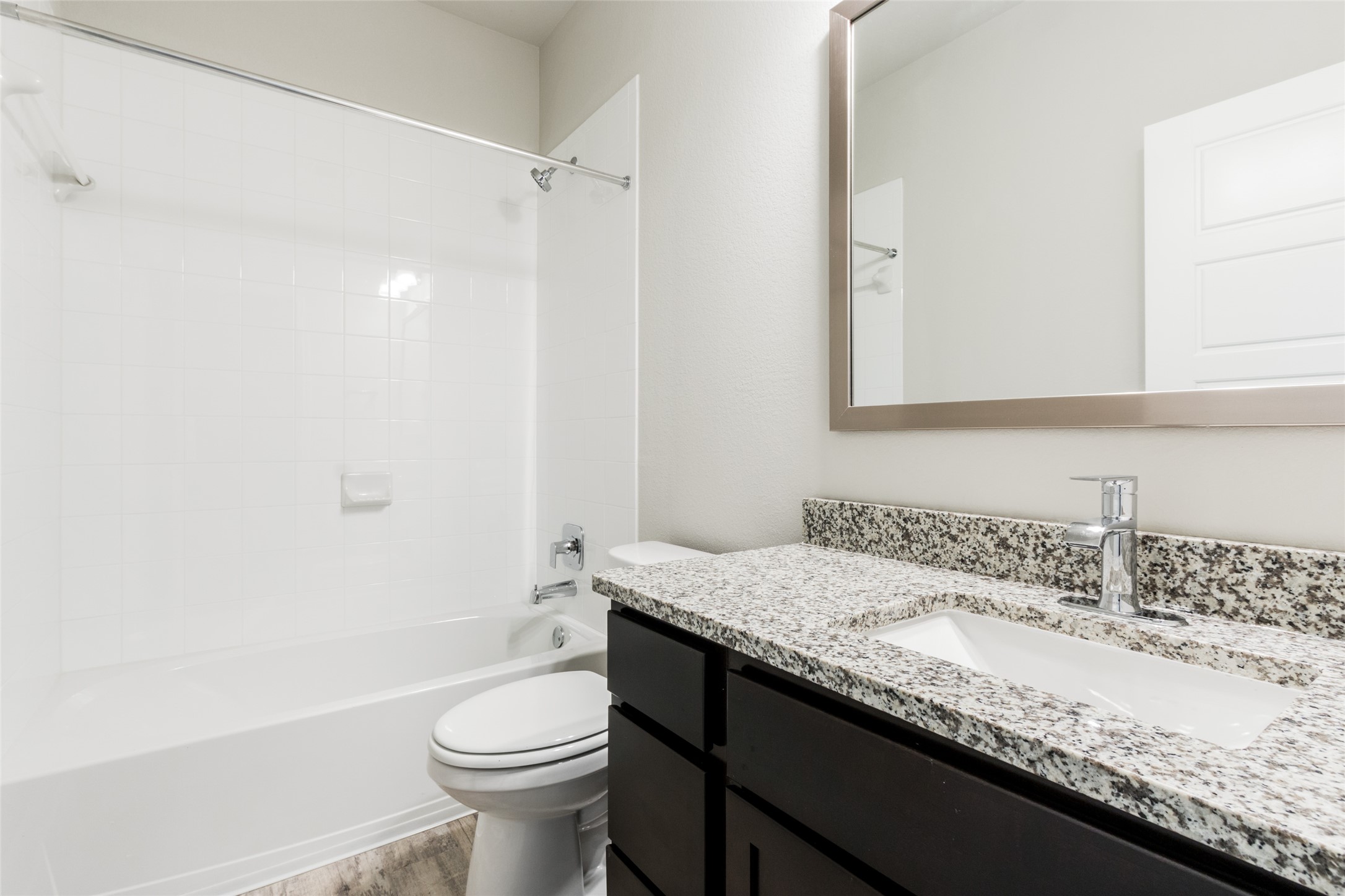 9301 Alex Lane Austin, TX 78748 - Photo 25 of 40 a bathroom with a granite countertop sink a toilet and a mirror