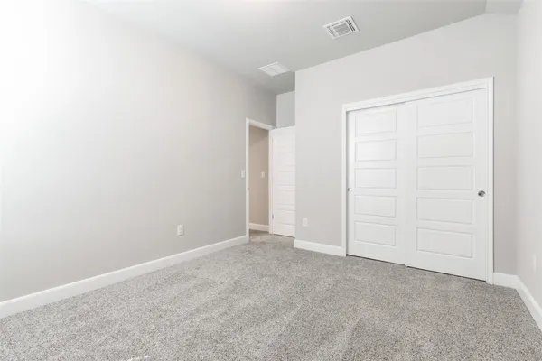 a bathroom with a granite countertop sink a toilet and a mirror
