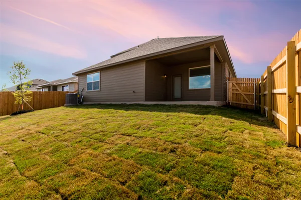 a view of a house with a backyard