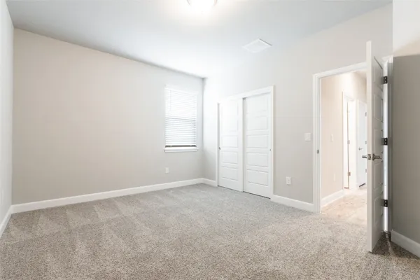 a view of an empty room and closet area