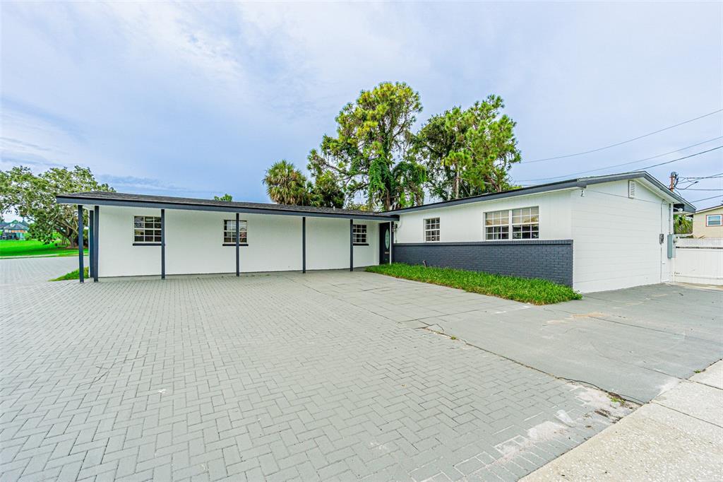 6428 Hanley Road Tampa, FL 33634 - Photo 1 of 1 front view of a house with a yard and a garage