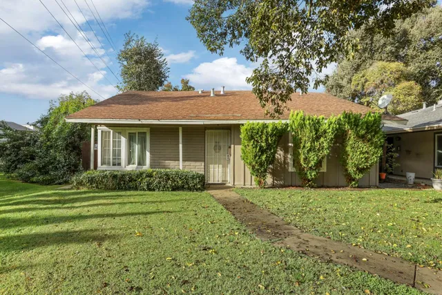 a front view of a house with a yard