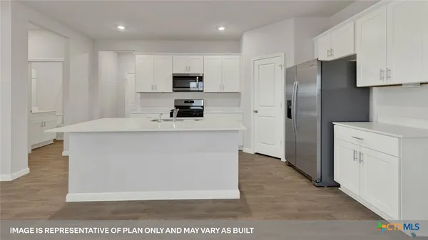 a kitchen with stainless steel appliances a refrigerator stove microwave and sink