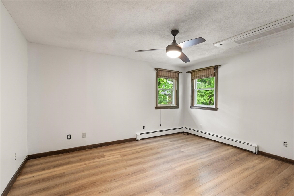 901 Haverhill Street Rowley, MA 01969 - Photo 25 of 42 wooden floor in an empty room with a window