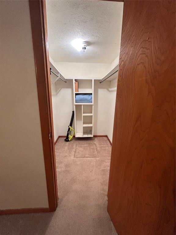 241 Aurora Street Rhome, TX 76078 - Photo 13 of 28 Spacious closet with carpet flooring in 2nd primary bedroom
