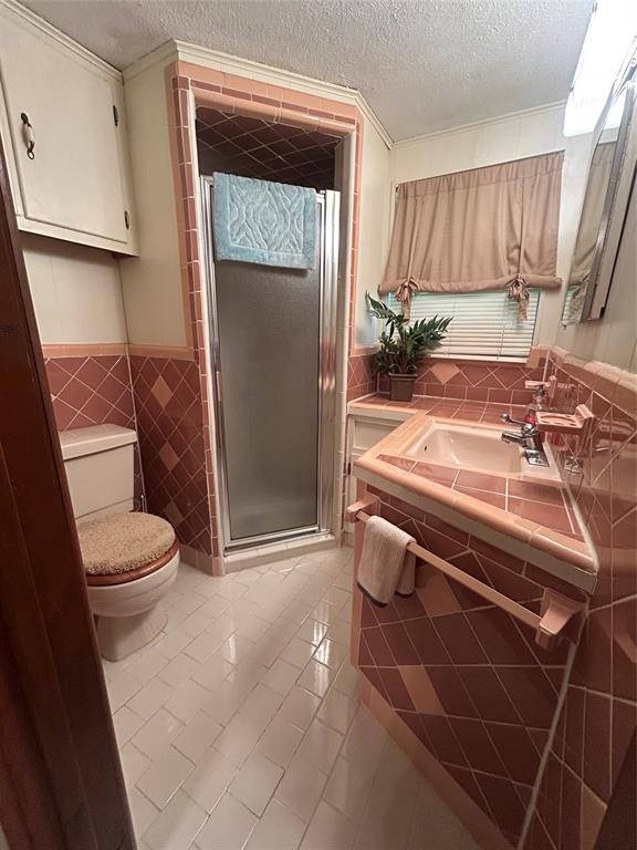 241 Aurora Street Rhome, TX 76078 - Photo 14 of 28 Tiled bathroom ensuite for 2nd primary bedroom