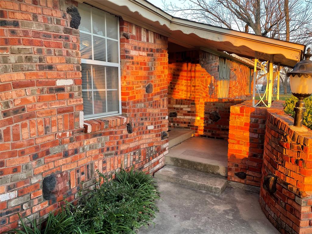 241 Aurora Street Rhome, TX 76078 - Photo 2 of 28 Property entrance featuring brick siding