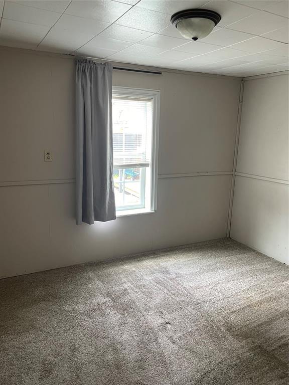 241 Aurora Street Rhome, TX 76078 - Photo 22 of 28 Carpeted empty room with a drop ceiling