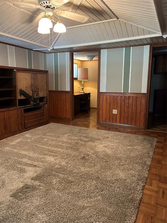 241 Aurora Street Rhome, TX 76078 - Photo 4 of 28 Den with ceiling fan, a wainscoted wall, and wooden walls