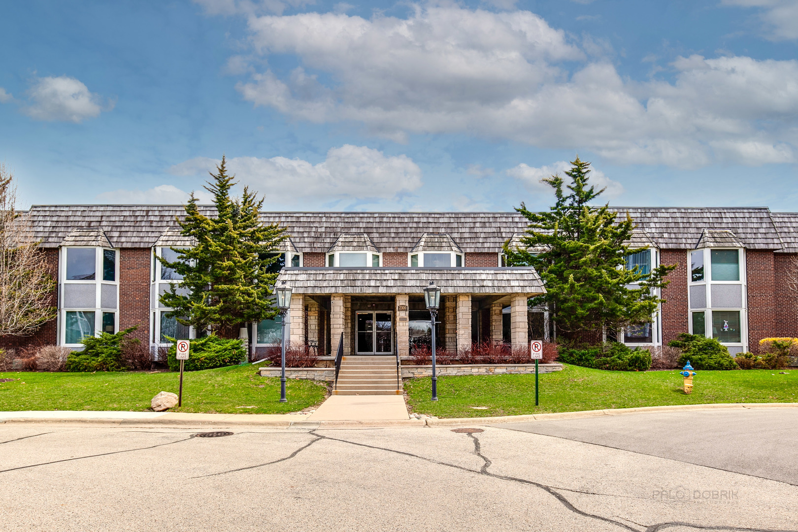 a view of a brick building next to a yard