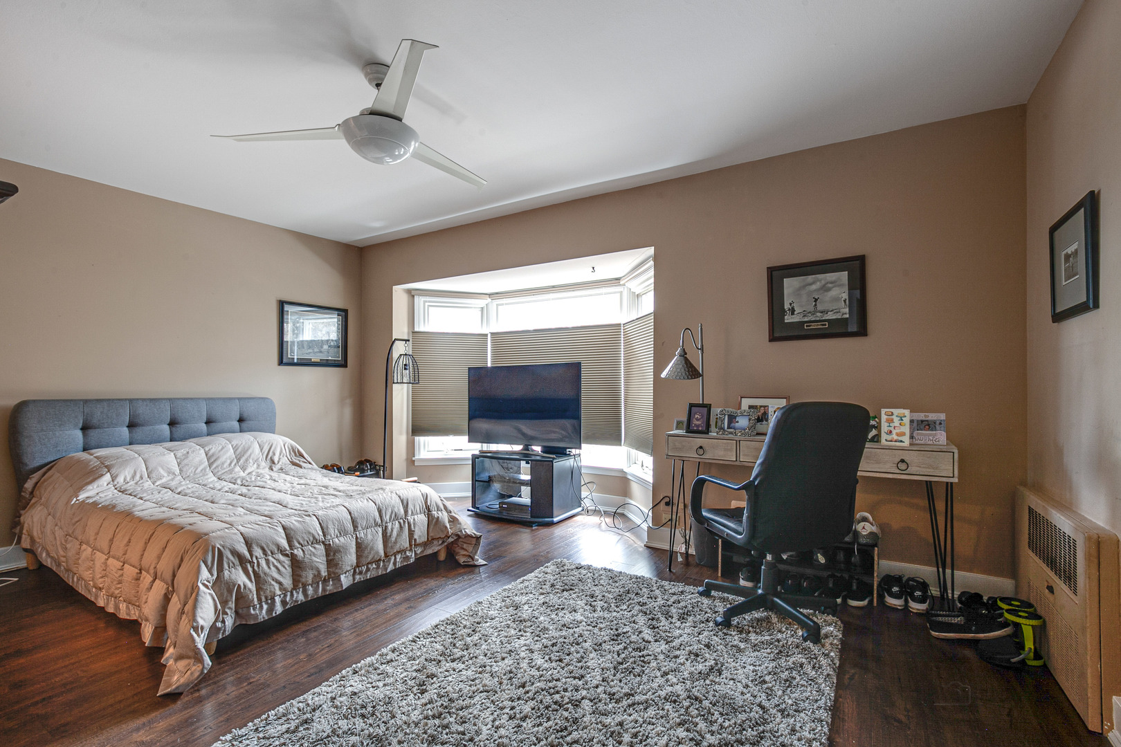 2300 Windsor Mall, Unit 2E Park Ridge, IL 60068 - Photo 20 of 23 a bedroom with a bed a large window and chair