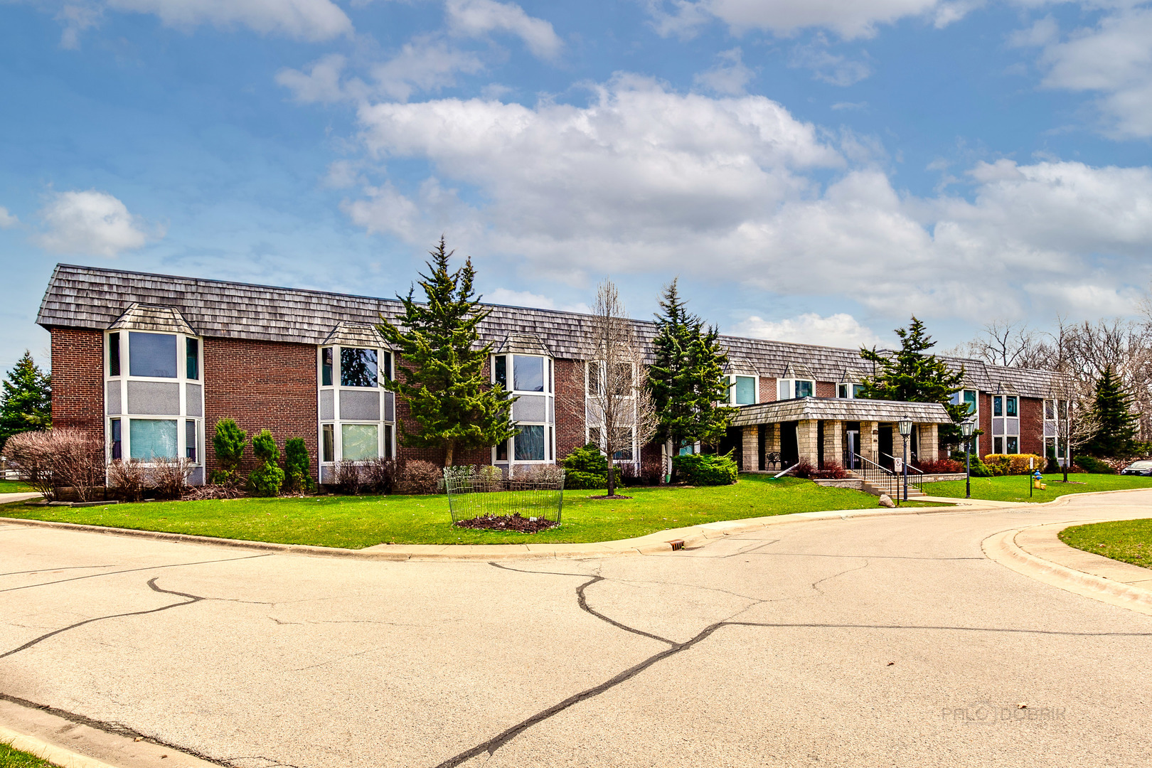 2300 Windsor Mall, Unit 2E Park Ridge, IL 60068 - Photo 2 of 23 a view of a building with a yard and plants