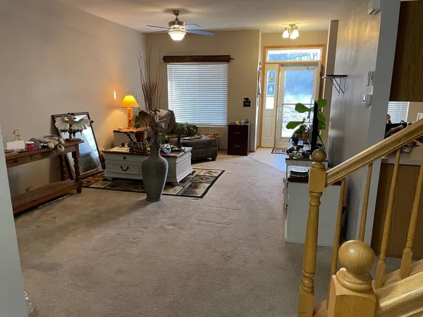 a view of a livingroom with furniture and a window