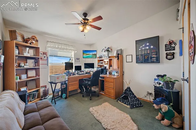 a view of a livingroom with workspace and a couch