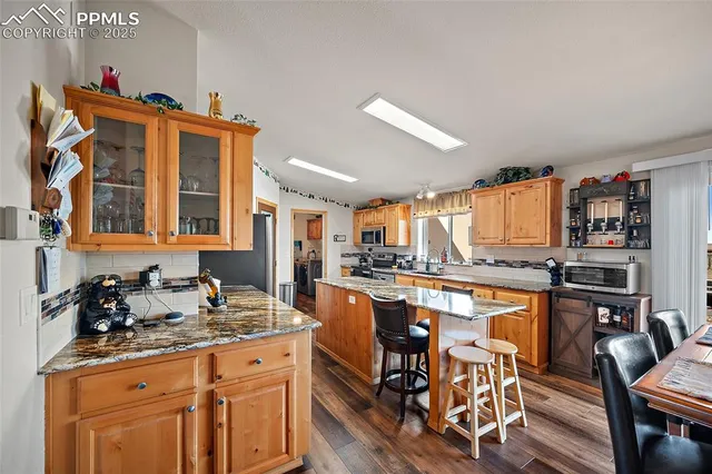 a kitchen with stainless steel appliances granite countertop a stove and cabinets