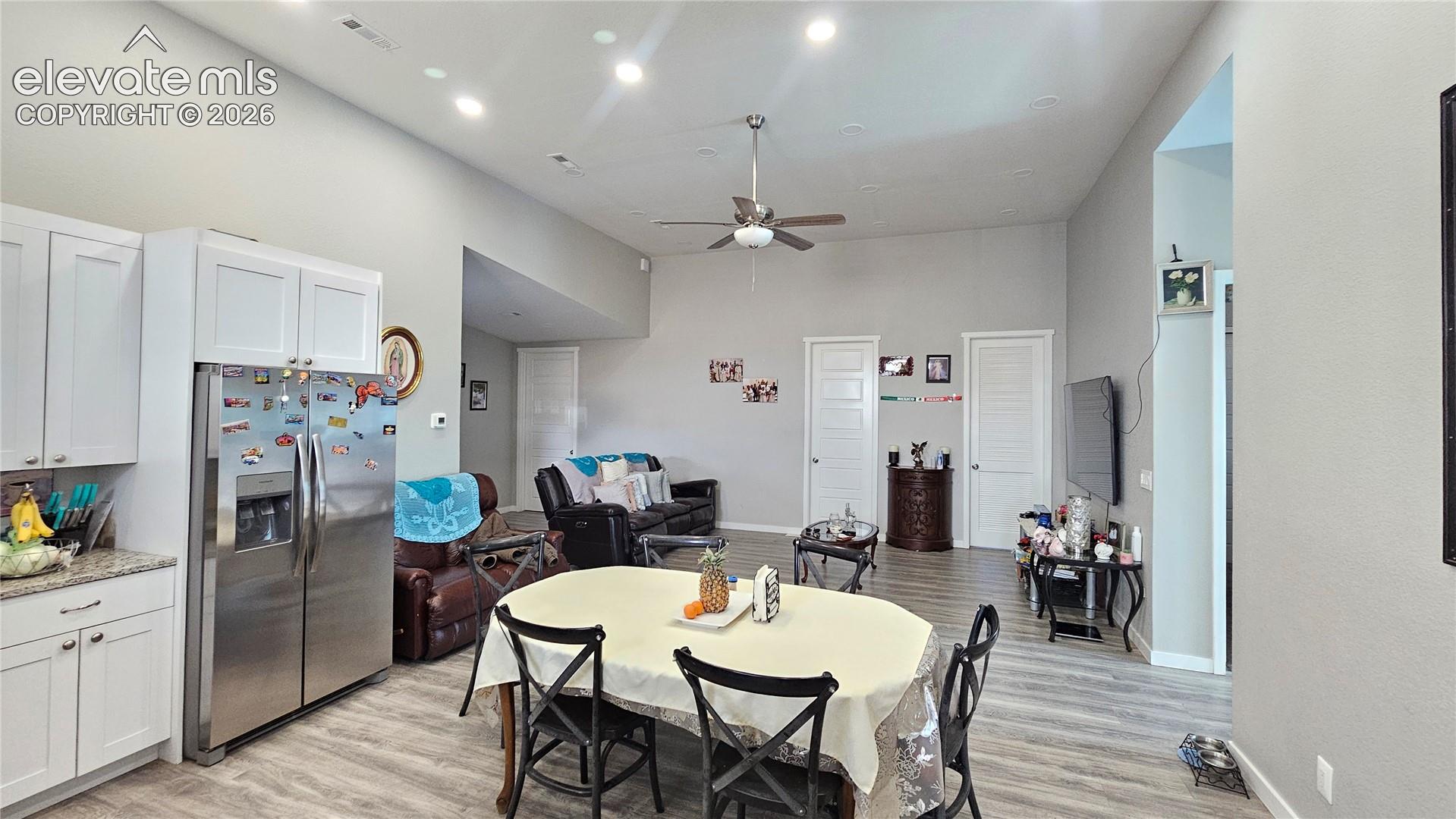 3835 Sengbeil Road Yoder, CO 80864 - Photo 16 of 48 Open-concept living area featuring high ceilings, recessed lighting, and wood-finish flooring