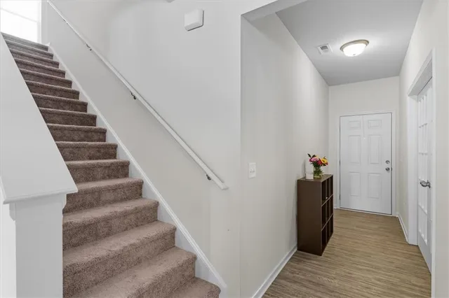 a view of entryway and hall with wooden floor