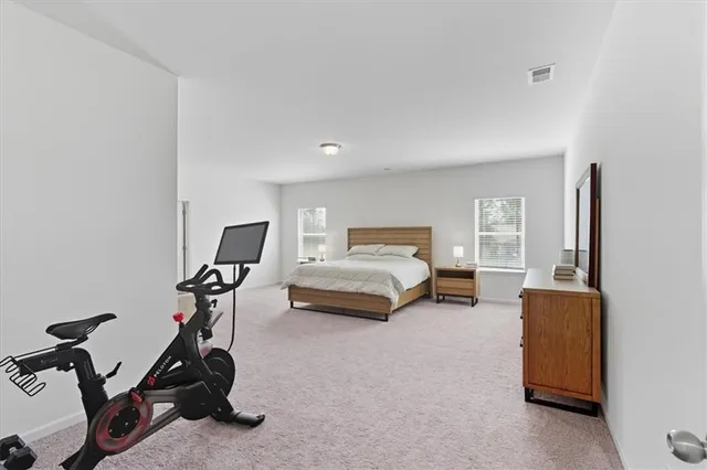 a bedroom with furniture and a gym equipment