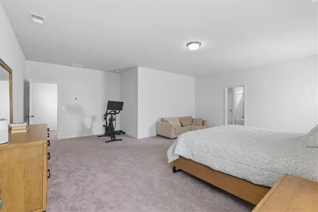 a bedroom with a bed and a lamp