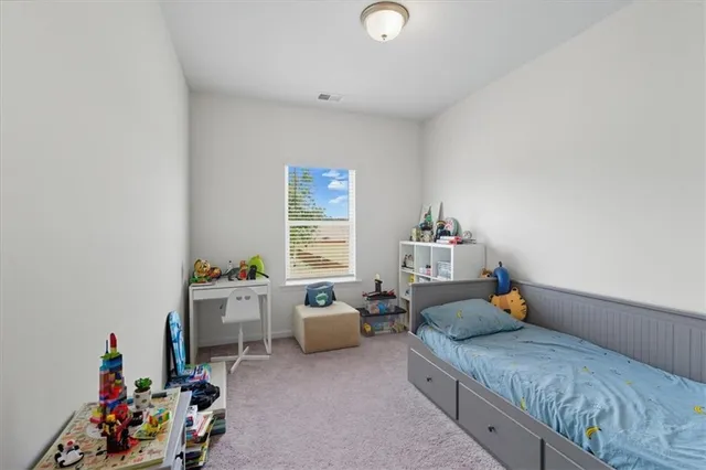 a bedroom with furniture a bed and a window