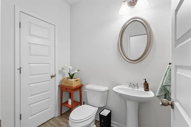 a bathroom with a sink a toilet and a mirror