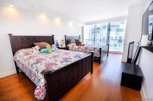 a bedroom with a bed and wooden floor