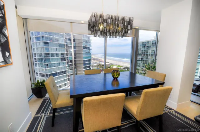 a view of a dining room with furniture and chandelier