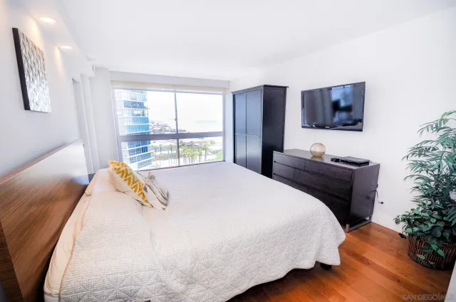 a bed sitting in a bedroom next to a window