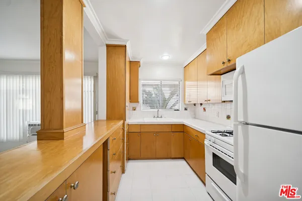 a large kitchen with a large window and stainless steel appliances