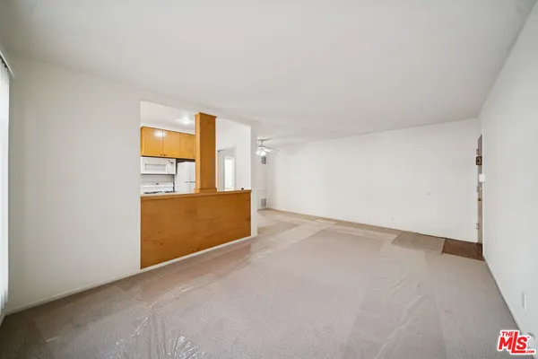a view of a room with a kitchen