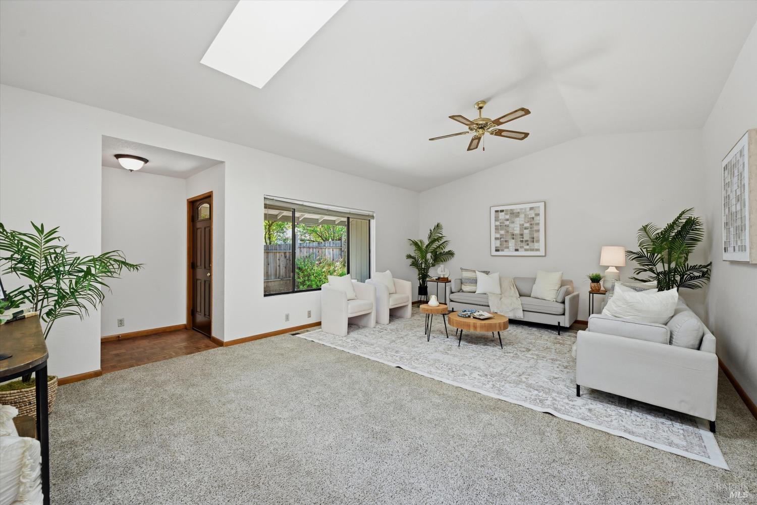 a living room with furniture and potted plant
