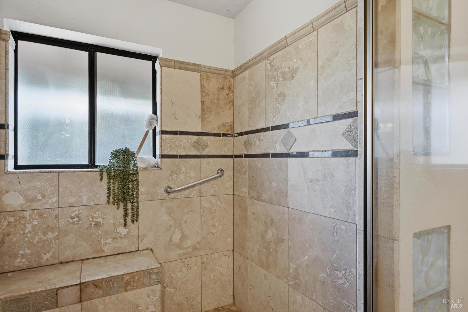 929 Helen Avenue Ukiah, CA 95482 - Photo 13 of 36 a bathroom with a glass shower door