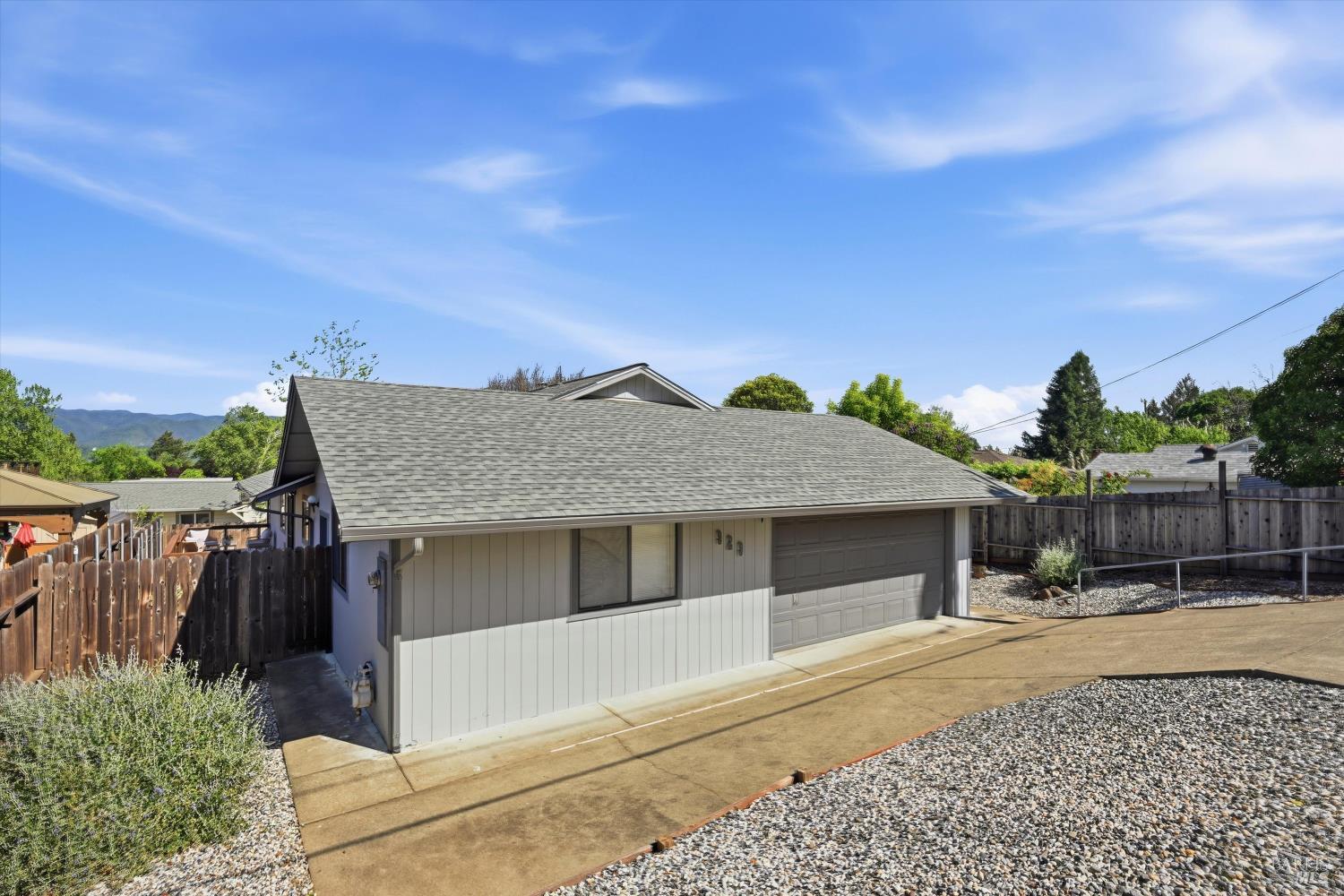 929 Helen Avenue Ukiah, CA 95482 - Photo 30 of 36 a front view of a house with a yard and garage