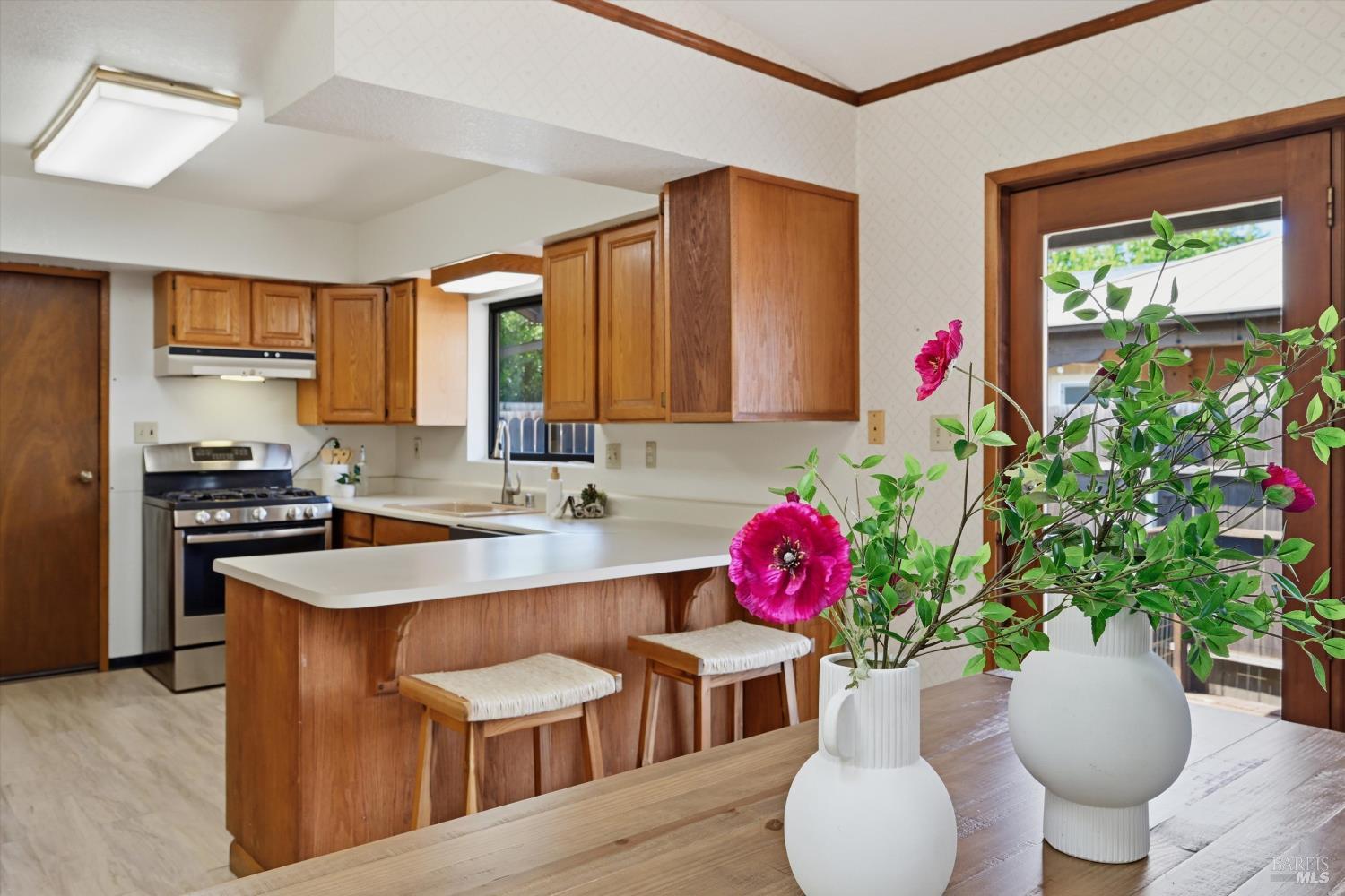 929 Helen Avenue Ukiah, CA 95482 - Photo 6 of 36 a kitchen with a potted plant and a table