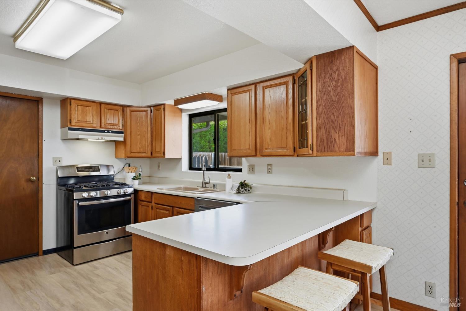 929 Helen Avenue Ukiah, CA 95482 - Photo 8 of 36 a kitchen with stainless steel appliances granite countertop a sink stove and refrigerator