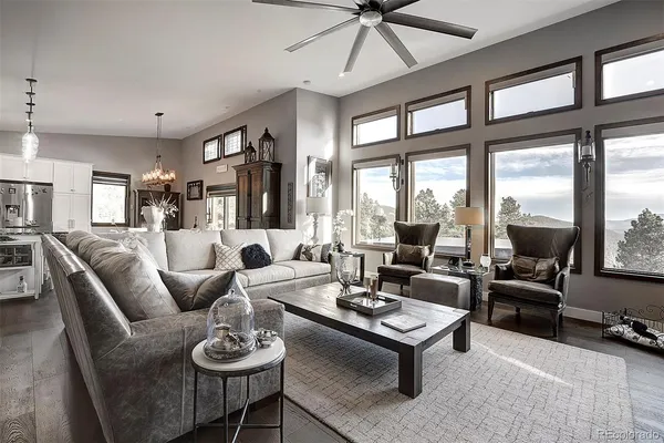 a living room with fireplace furniture and a wooden floor