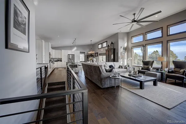 a spacious bedroom with a bed a couch and large window