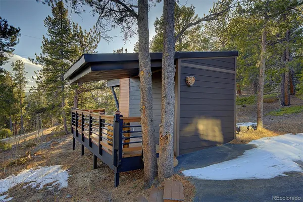 an aerial view of a house with balcony and trees