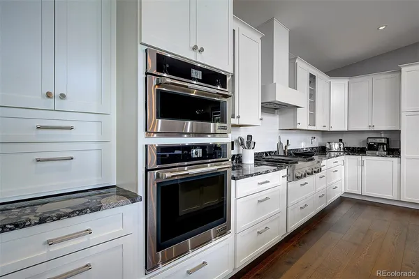 a stove top oven sitting inside of a kitchen