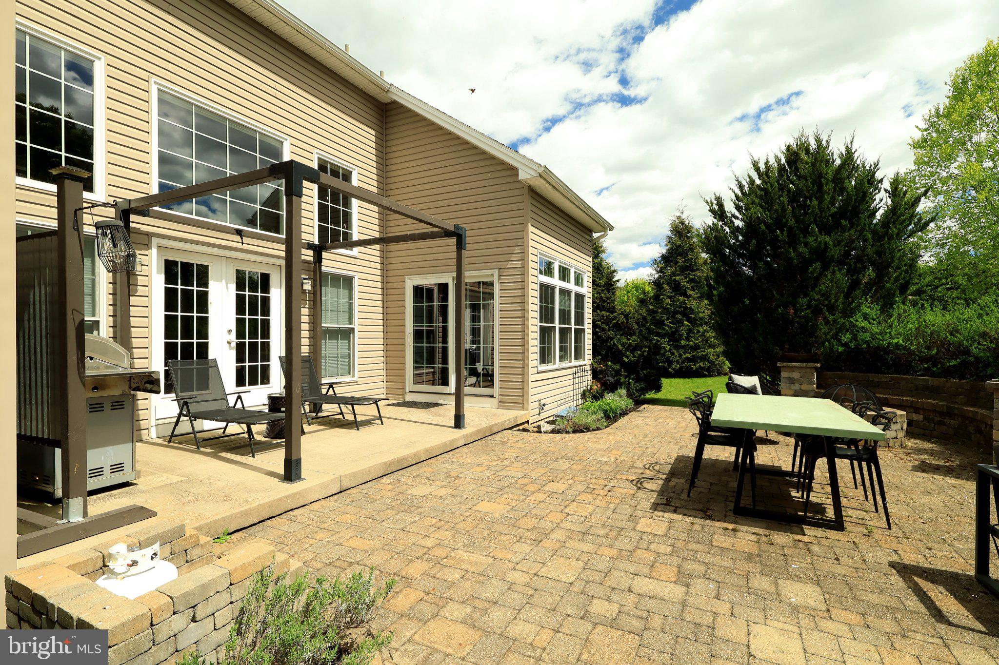 170 Fernleaf Court State College, PA 16801 - Photo 61 of 63 Sunny patio with lush greenery.