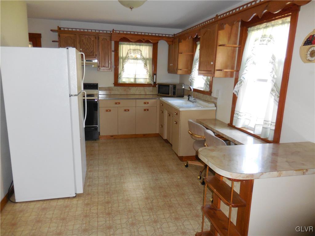 8428 Rextown Road Slatington, PA 18080 - Photo 5 of 25 a kitchen with a refrigerator a sink and a window