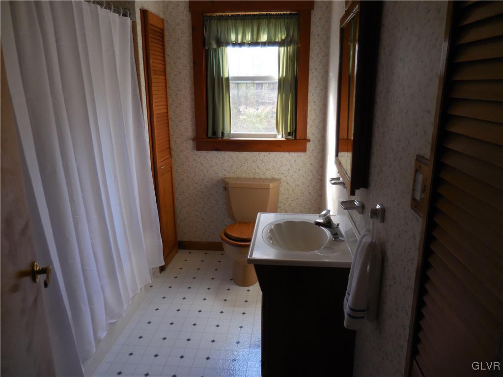 8428 Rextown Road Slatington, PA 18080 - Photo 10 of 25 a bathroom with a sink toilet and window