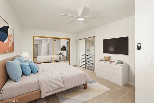 a bedroom with a large bed and a flat screen tv