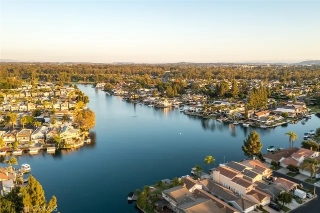 an aerial view of lake and residential houses with outdoor space