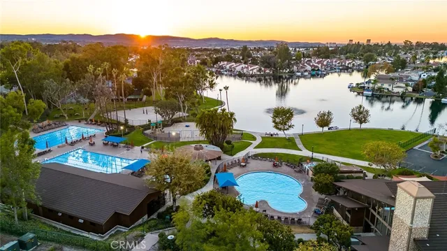 an aerial view of a house with a garden and lake view