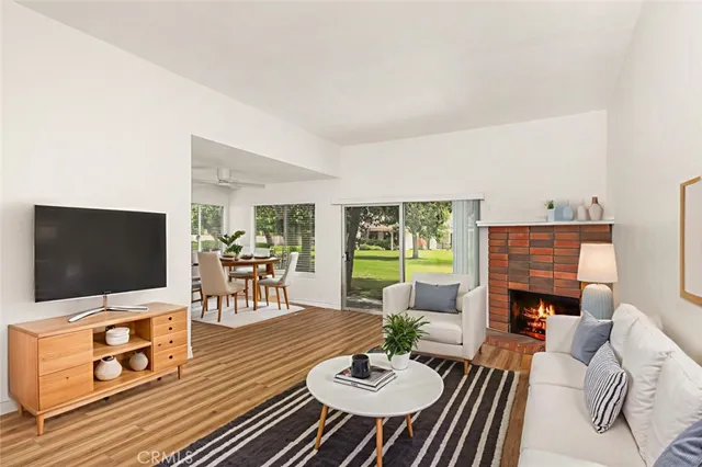 a living room with fireplace furniture and a flat screen tv