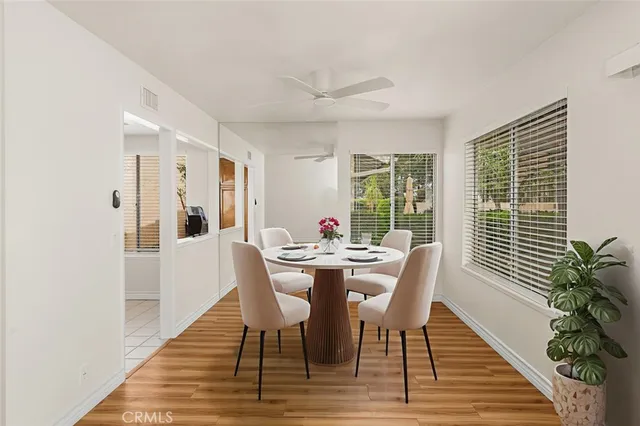 a dining room with furniture window and wooden floor