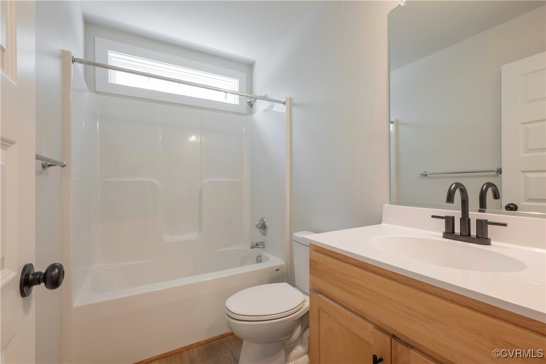 3020 Botone Avenue Richmond, VA 23237 - Photo 30 of 33 a bathroom with a sink a toilet and a mirror