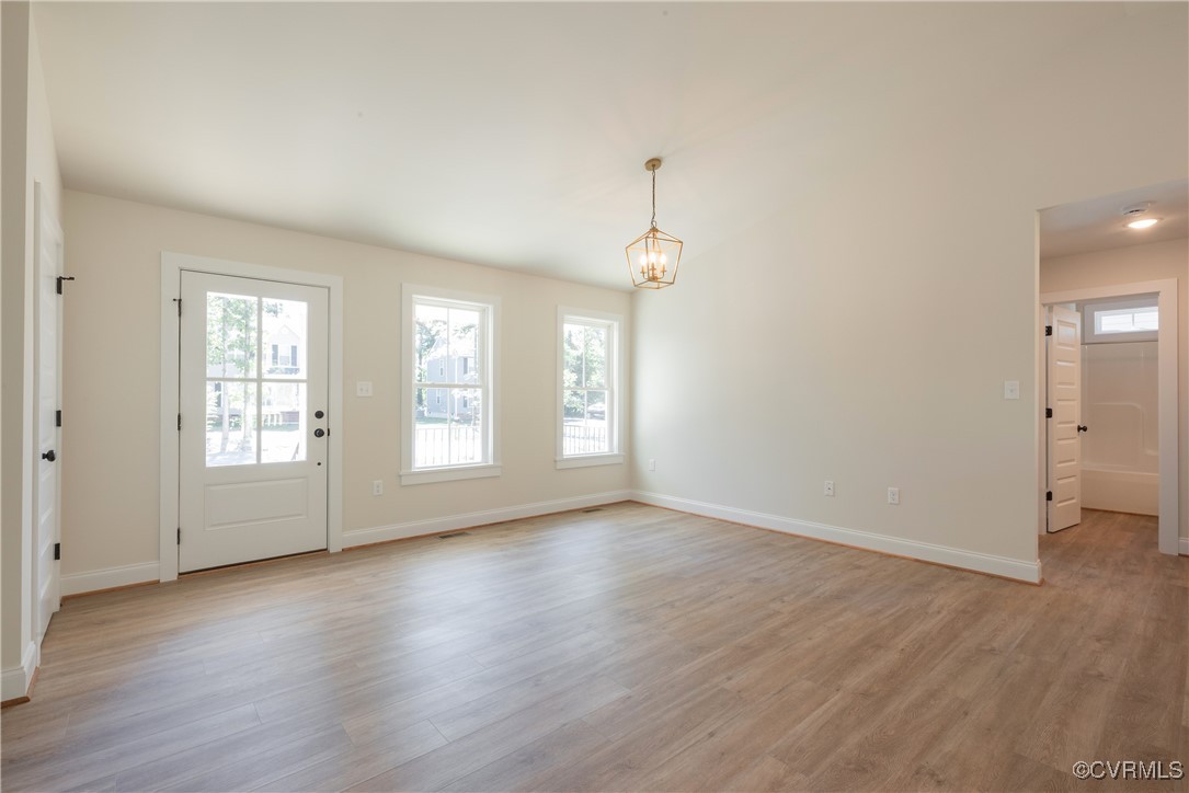 3020 Botone Avenue Richmond, VA 23237 - Photo 10 of 33 an empty room with wooden floor and windows